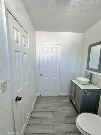 a bathroom with a sink a toilet a shower and a mirror
