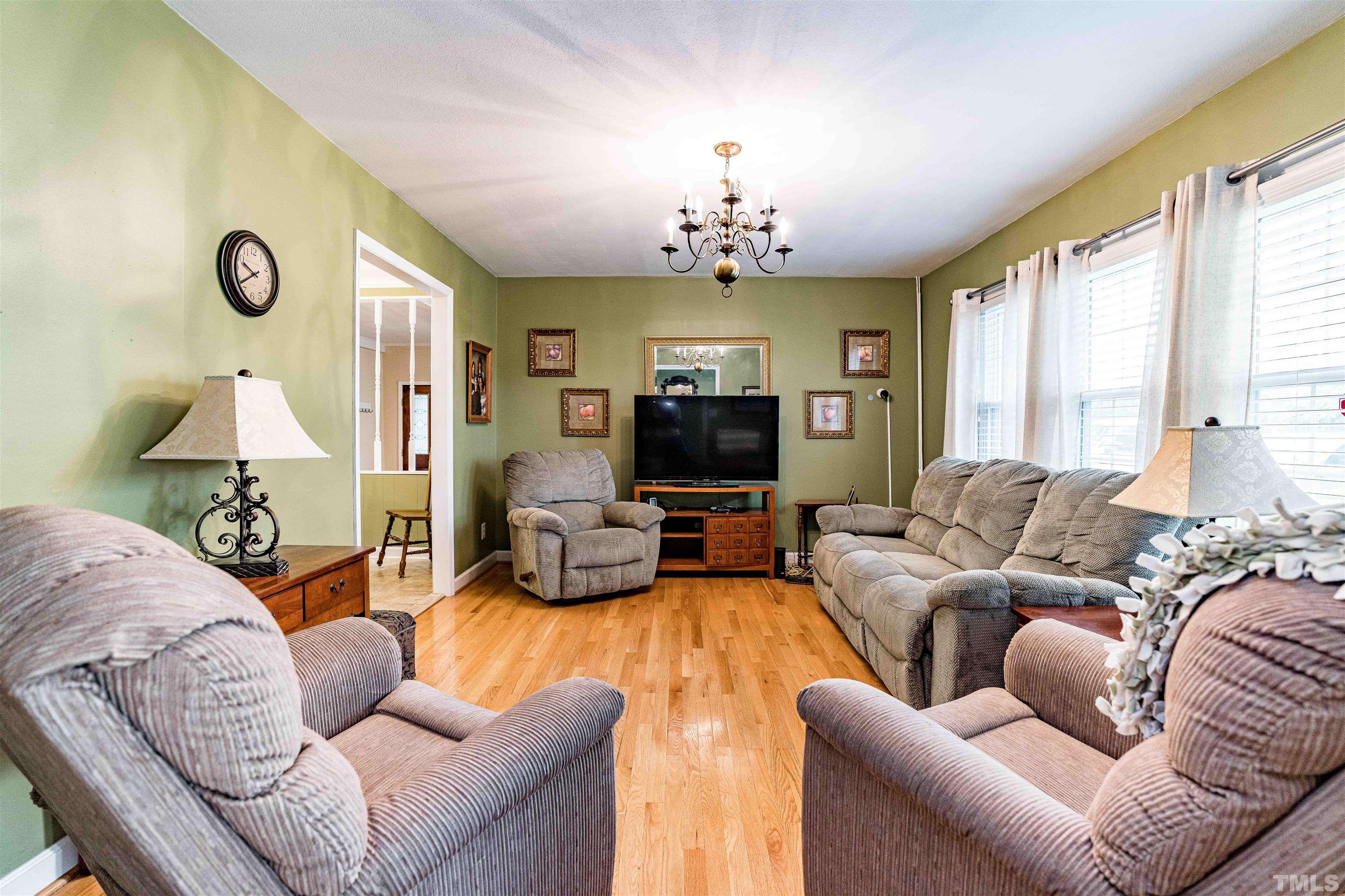 2052 Jack Road Clayton, NC 27520 - Photo 11 of 37 a living room with furniture flat screen tv and a large window