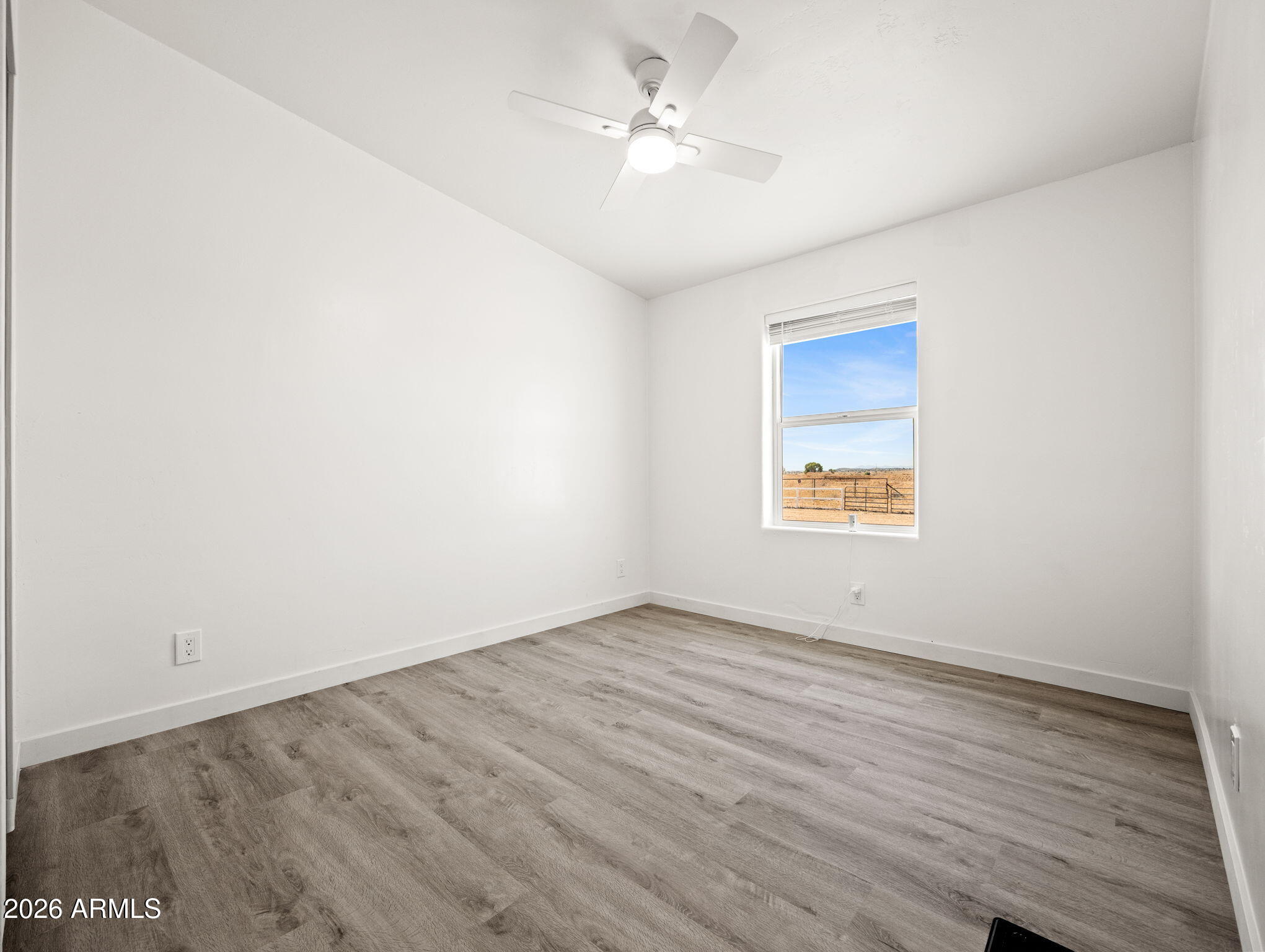1754 West Deadwood Ranch Road Paulden, AZ 86334 - Photo 29 of 51 an empty room with a window and a ceiling fan
