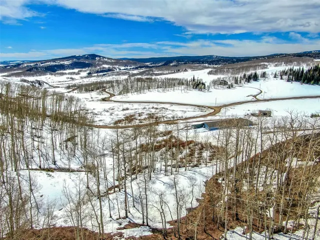 a view of a yard with a building in the background