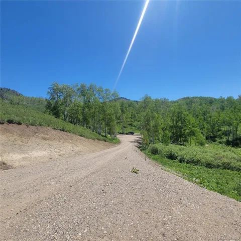 a view of a field with trees in it