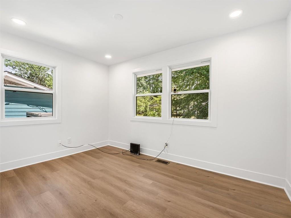 454 Oak Drive Southeast Atlanta, GA 30354 - Photo 20 of 29 an empty room with wooden floor and windows