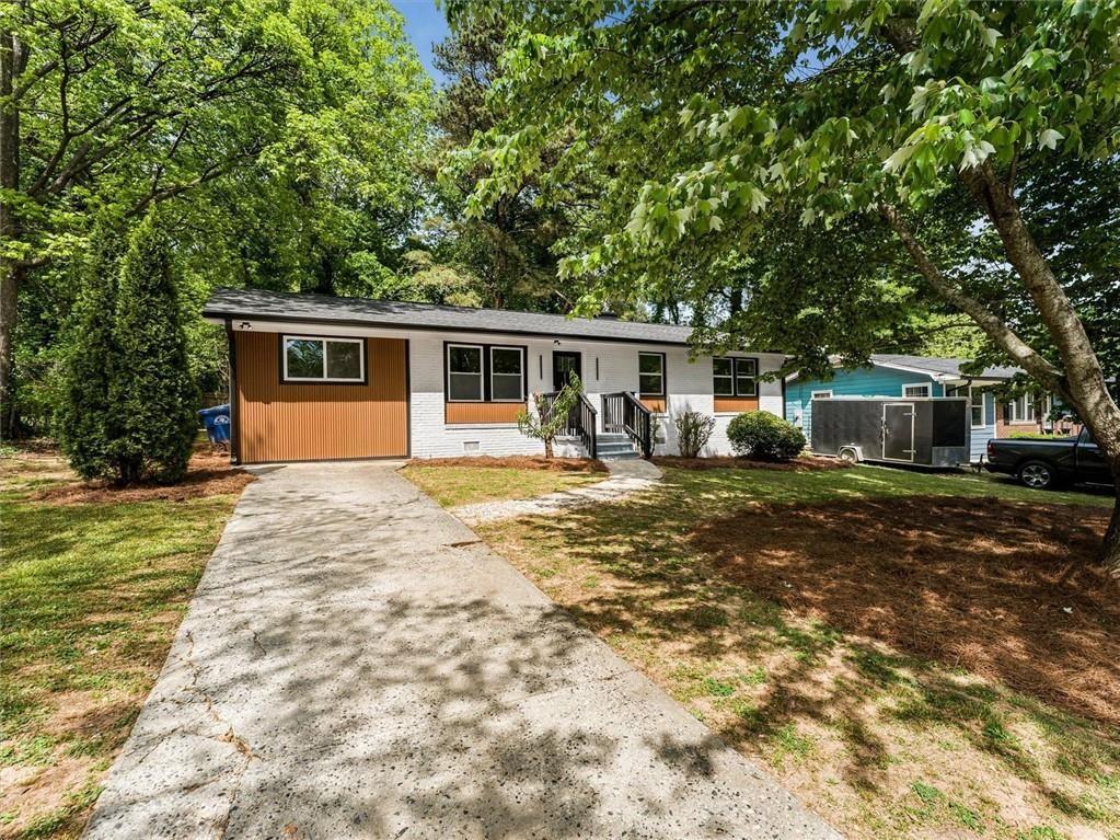 454 Oak Drive Southeast Atlanta, GA 30354 - Photo 2 of 29 a front view of house with yard and trees in the background