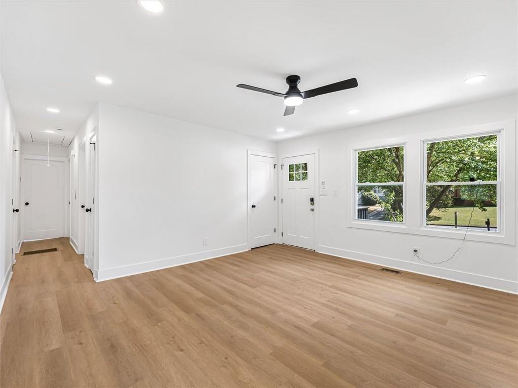454 Oak Drive Southeast Atlanta, GA 30354 - Photo 6 of 29 a view of an empty room with wooden floor and a window