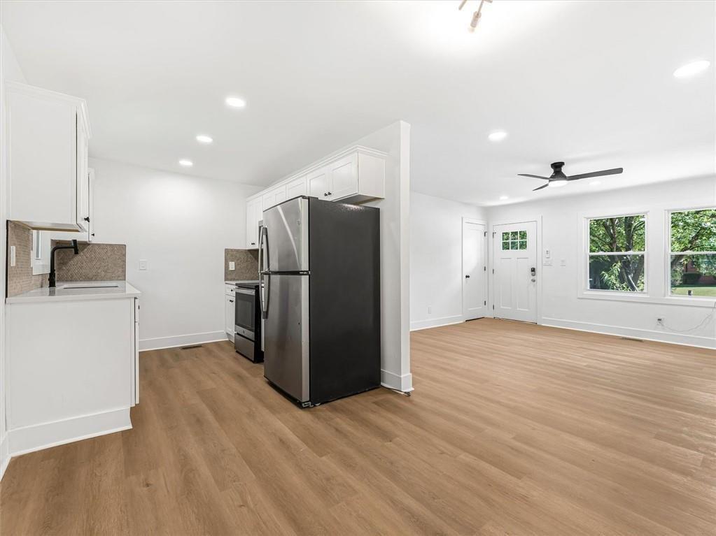454 Oak Drive Southeast Atlanta, GA 30354 - Photo 8 of 29 a view of a kitchen with wooden floor and a refrigerator