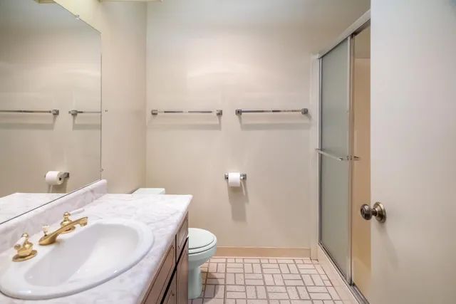 a bathroom with a sink toilet and shower