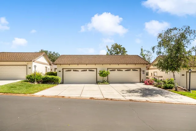 a view of a house with a yard and garage