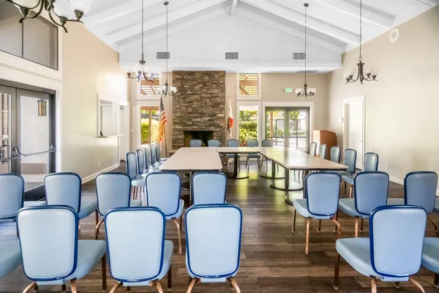 a view of a patio with table and chairs and potted plants