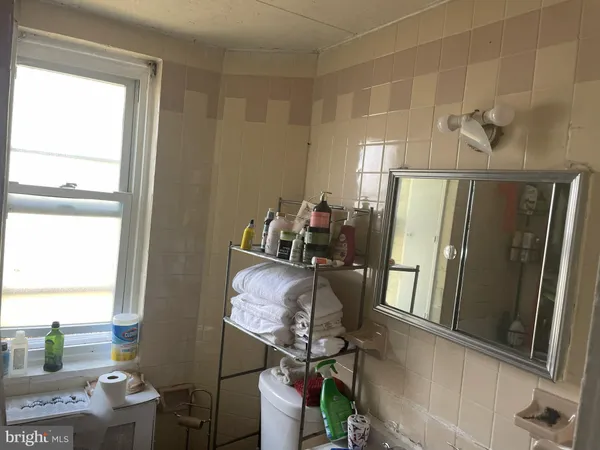 a view of kitchen with furniture and refrigerator