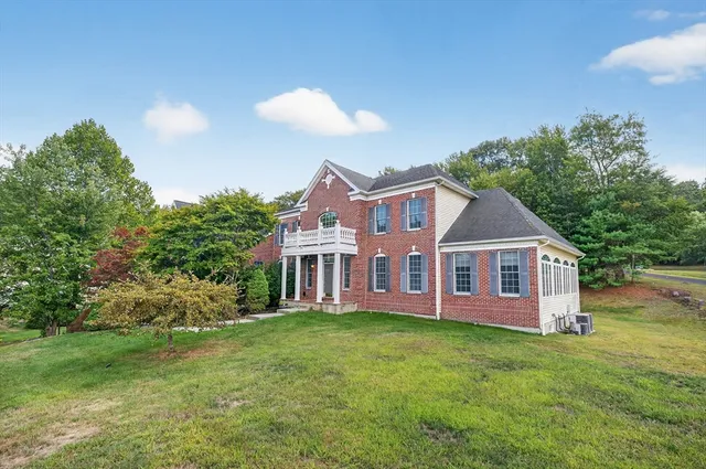 a view of a house with a backyard