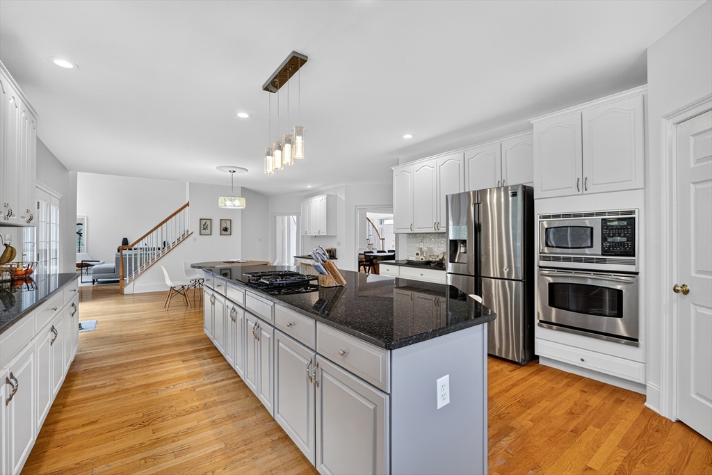 4 Summit Way, Unit 1 Hopkinton, MA 01748 - Photo 12 of 27 a kitchen with stainless steel appliances granite countertop a stove and a refrigerator