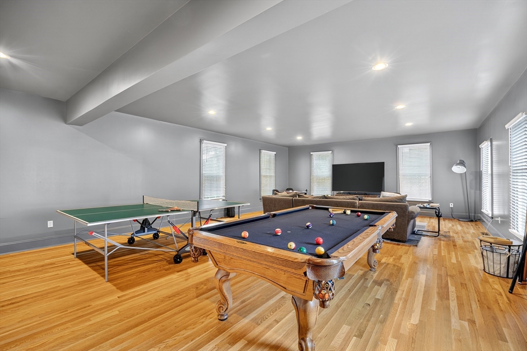 4 Summit Way, Unit 1 Hopkinton, MA 01748 - Photo 15 of 27 a room with furniture and a flat screen tv