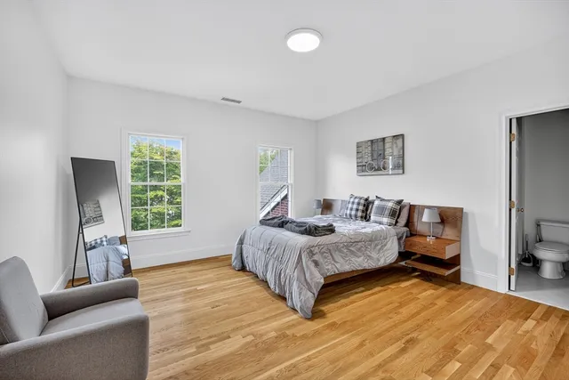 a spacious bedroom with a bed couch and a window