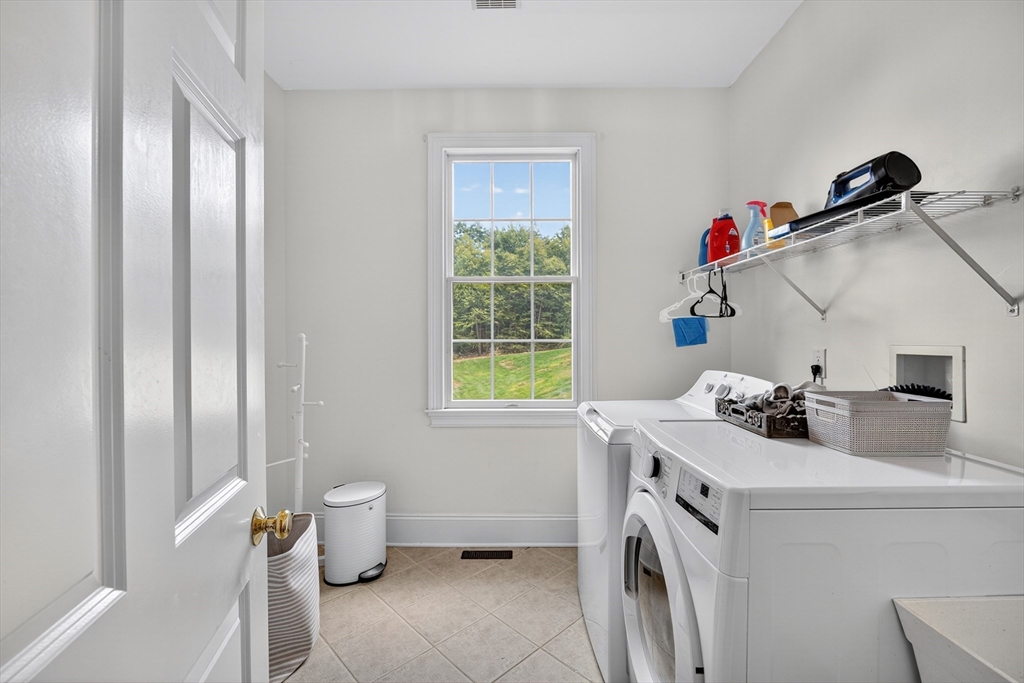 4 Summit Way, Unit 1 Hopkinton, MA 01748 - Photo 24 of 27 a storage room with washer and dryer