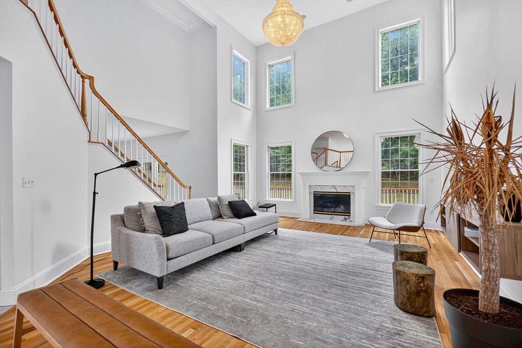 4 Summit Way, Unit 1 Hopkinton, MA 01748 - Photo 4 of 27 a living room with furniture and a fireplace