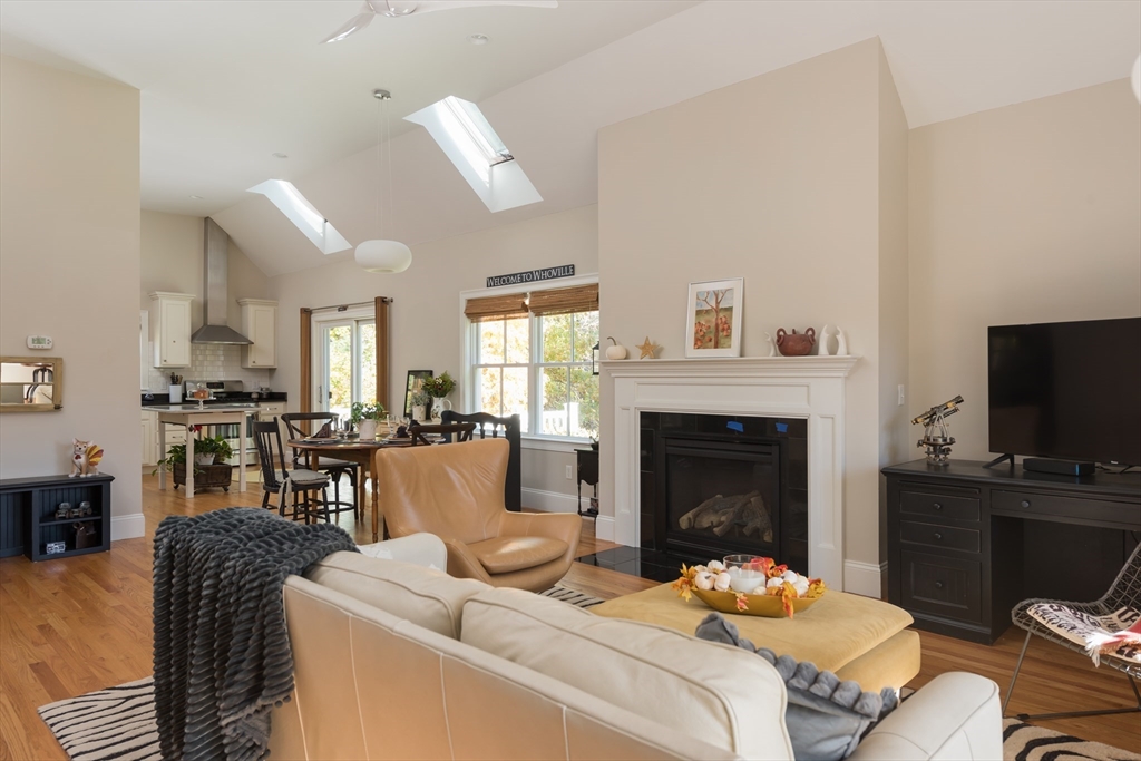 57 Hathaway Pond Circle, Unit 57 Rochester, MA 02770 - Photo 14 of 40 a living room with furniture a fireplace and a flat screen tv
