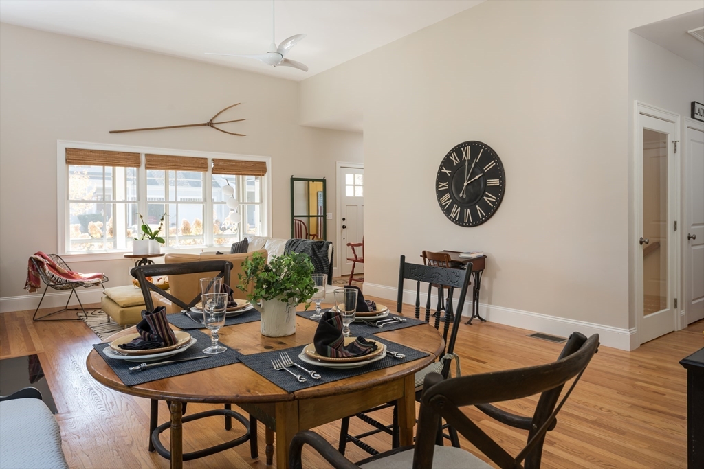 57 Hathaway Pond Circle, Unit 57 Rochester, MA 02770 - Photo 15 of 40 a view of a dining room with furniture window and wooden floor