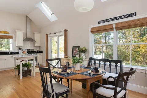 a kitchen with a sink a window and cabinets