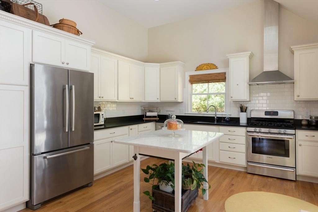 57 Hathaway Pond Circle, Unit 57 Rochester, MA 02770 - Photo 18 of 40 a kitchen with a white cabinets and stainless steel appliances