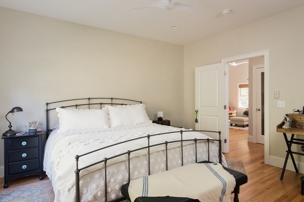 57 Hathaway Pond Circle, Unit 57 Rochester, MA 02770 - Photo 22 of 40 a bedroom with a bed and a table