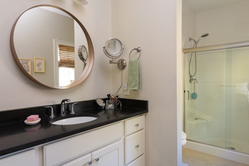 57 Hathaway Pond Circle, Unit 57 Rochester, MA 02770 - Photo 24 of 40 a bathroom with a sink and a mirror