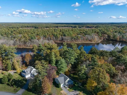 an aerial view of a house with a yard