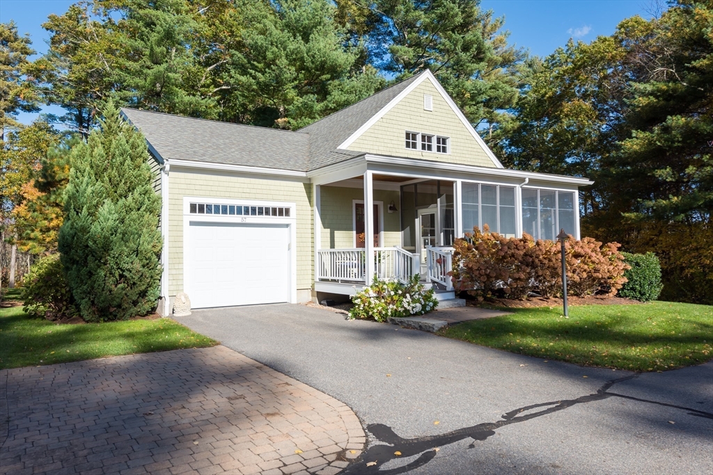 57 Hathaway Pond Circle, Unit 57 Rochester, MA 02770 - Photo 3 of 40 a front view of a house with a garden and trees