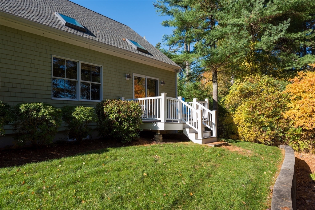 57 Hathaway Pond Circle, Unit 57 Rochester, MA 02770 - Photo 5 of 40 a front view of a house with garden