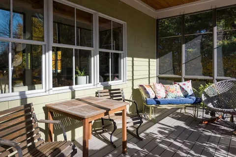 a view of an outdoor sitting area with brick walls