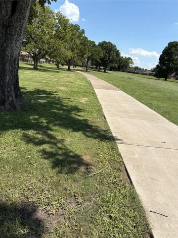 a view of yard with swimming pool and green space
