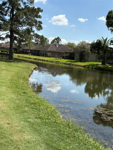 a view of a lake with houses in the back
