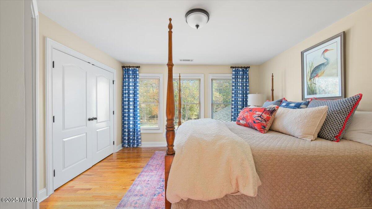 1060 East Magnolia Loop Madison, GA 30650 - Photo 24 of 41 a bed room with a bed mirror and a window