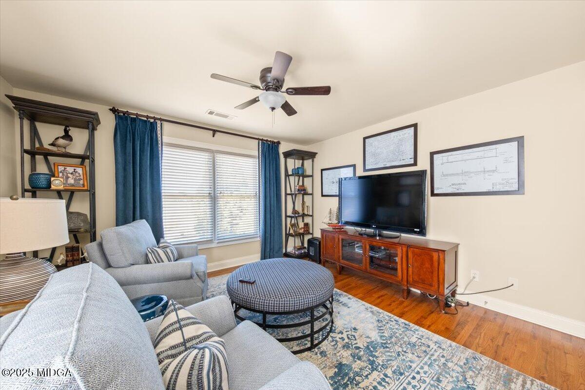 1060 East Magnolia Loop Madison, GA 30650 - Photo 27 of 41 a living room with furniture and a flat screen tv