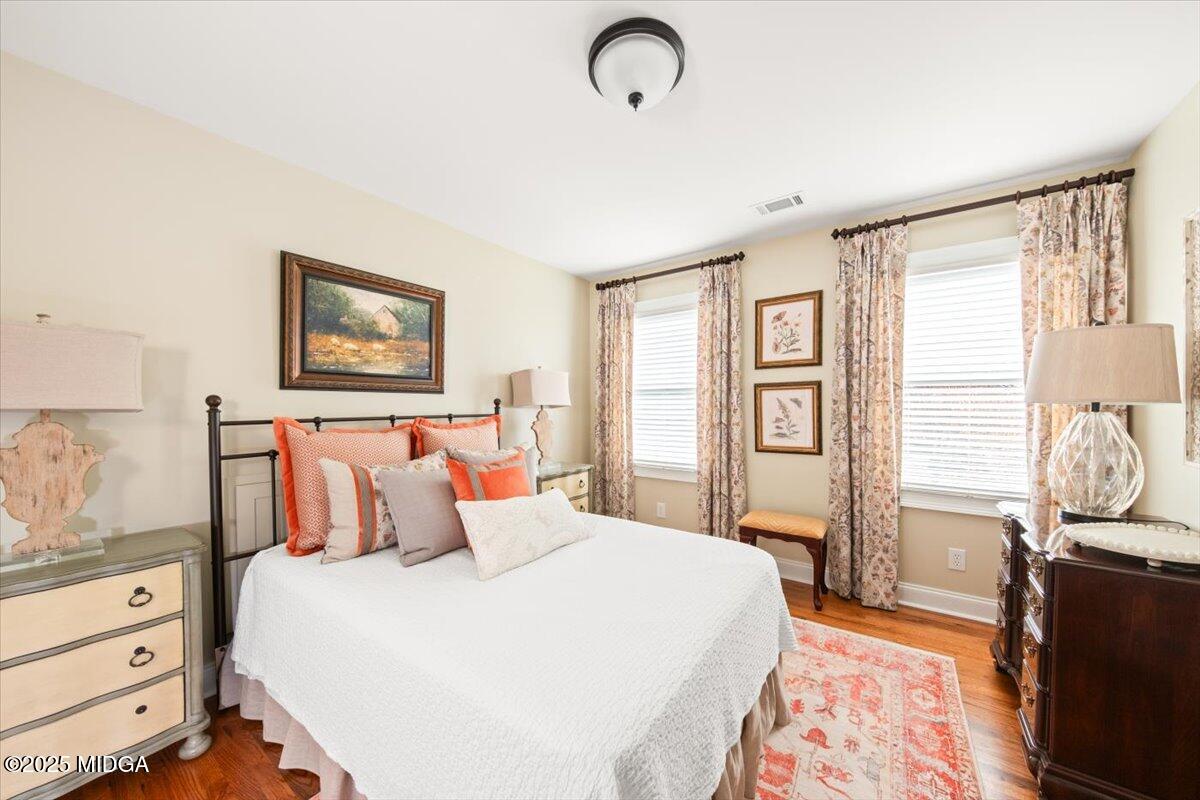 1060 East Magnolia Loop Madison, GA 30650 - Photo 31 of 41 a bedroom with a bed and wooden floor