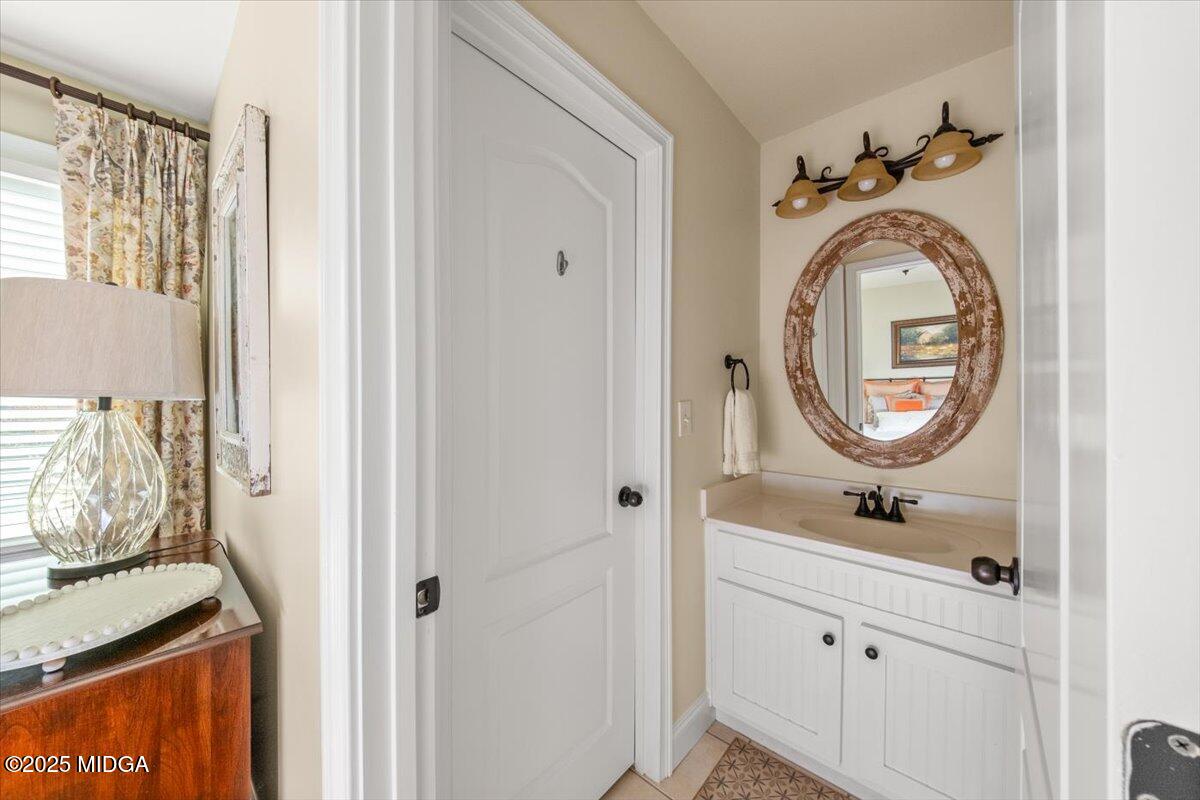 1060 East Magnolia Loop Madison, GA 30650 - Photo 33 of 41 a bathroom with a sink and a mirror