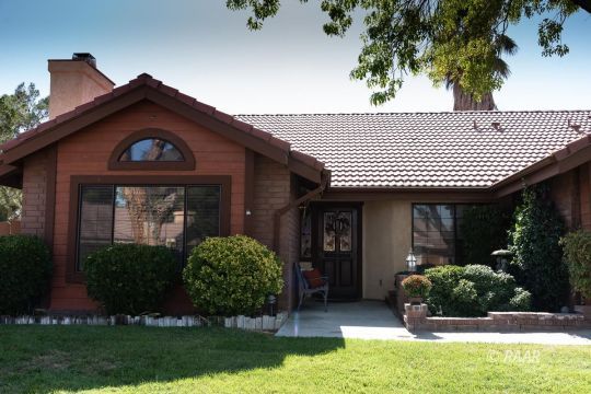 323 West Pilgrim Court Ridgecrest, CA 93555 - Photo 2 of 35 a front view of a house with garden
