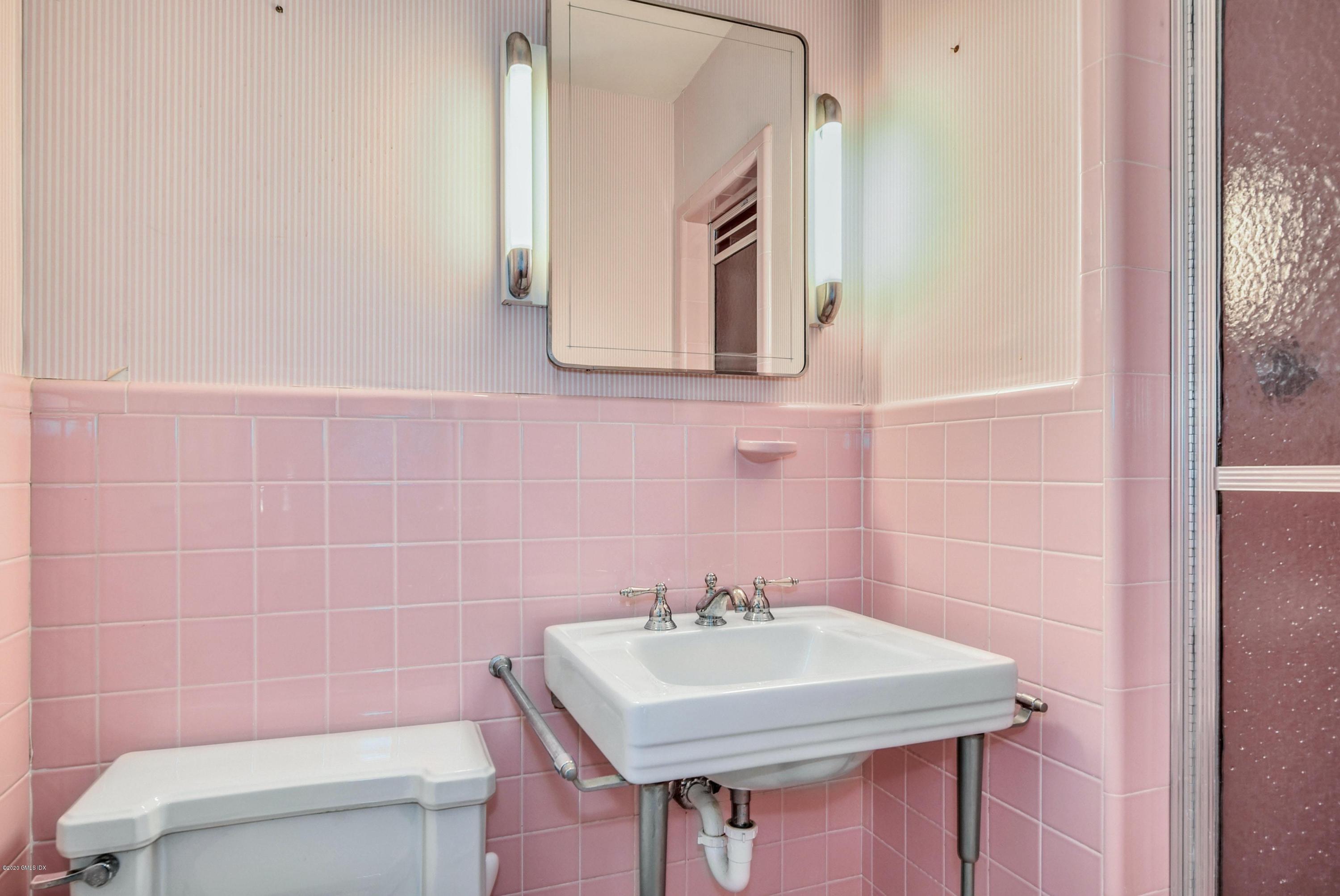 230 Stanwich Road Greenwich, CT 06830 - Photo 19 of 28 a bathroom with a sink a toilet and mirror