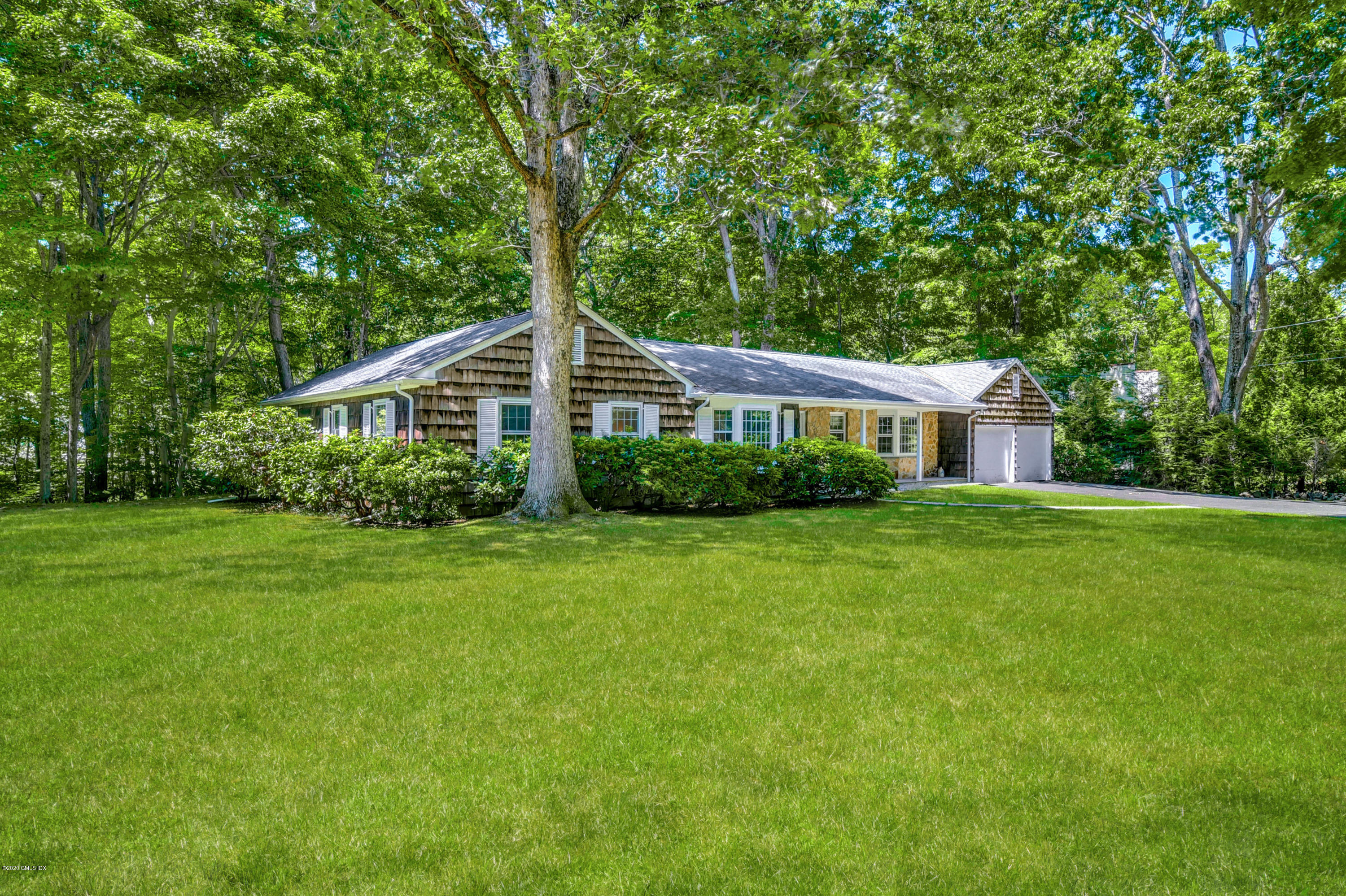 230 Stanwich Road Greenwich, CT 06830 - Photo 2 of 28 a front view of a house with a yard and green space