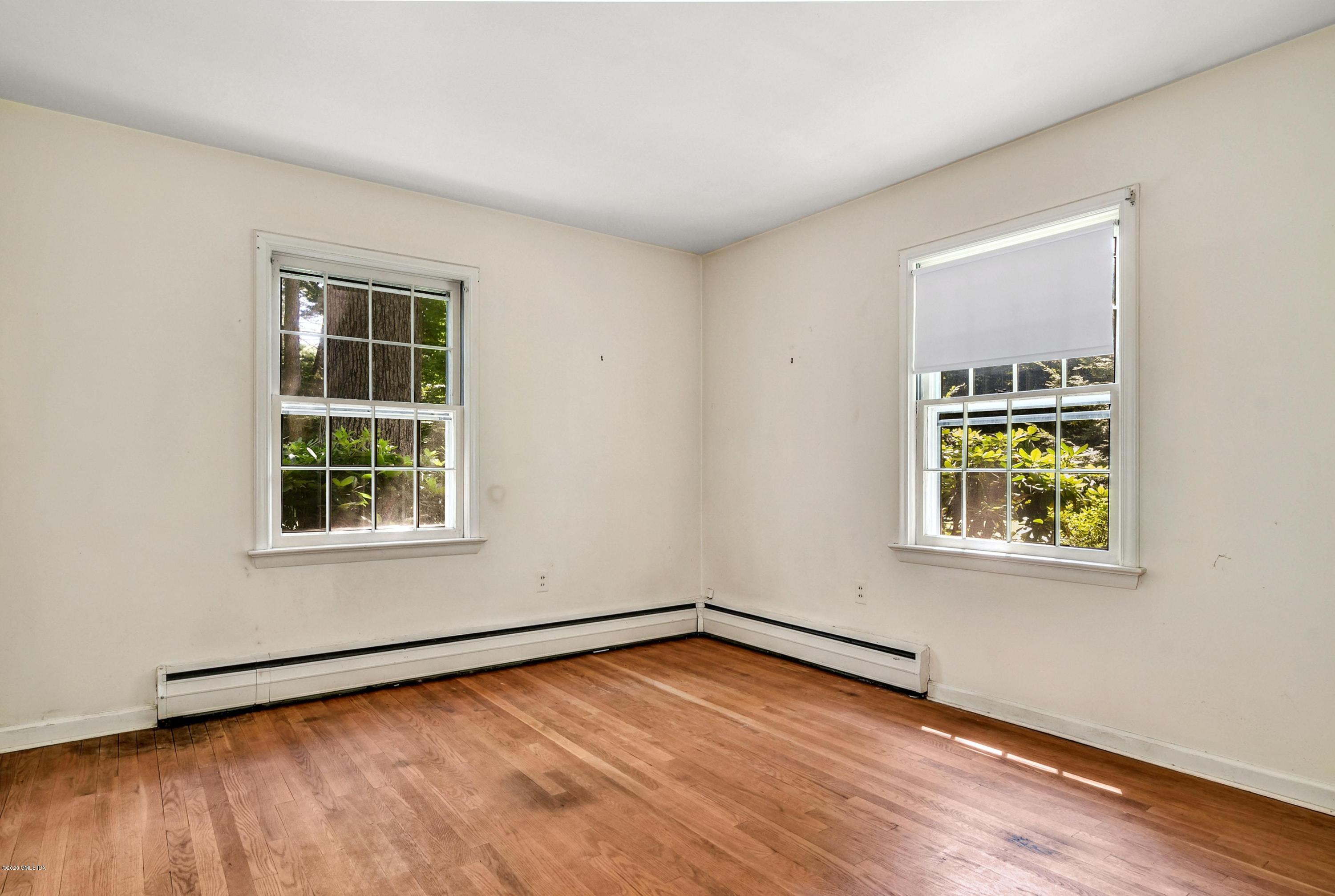 230 Stanwich Road Greenwich, CT 06830 - Photo 21 of 28 a view of an empty room with wooden floor and a window