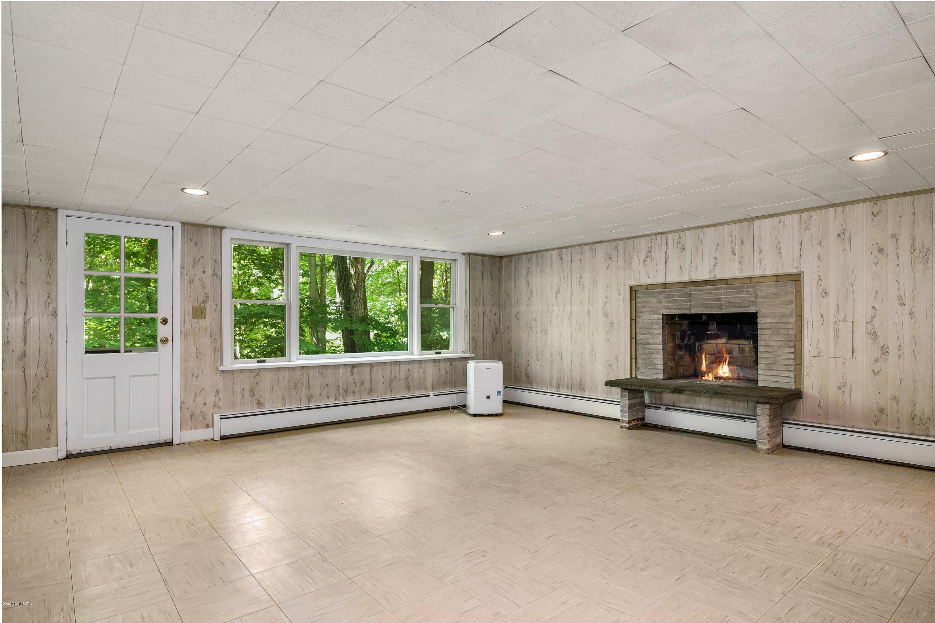 230 Stanwich Road Greenwich, CT 06830 - Photo 25 of 28 an empty room with floor to ceiling window and floor to ceiling window