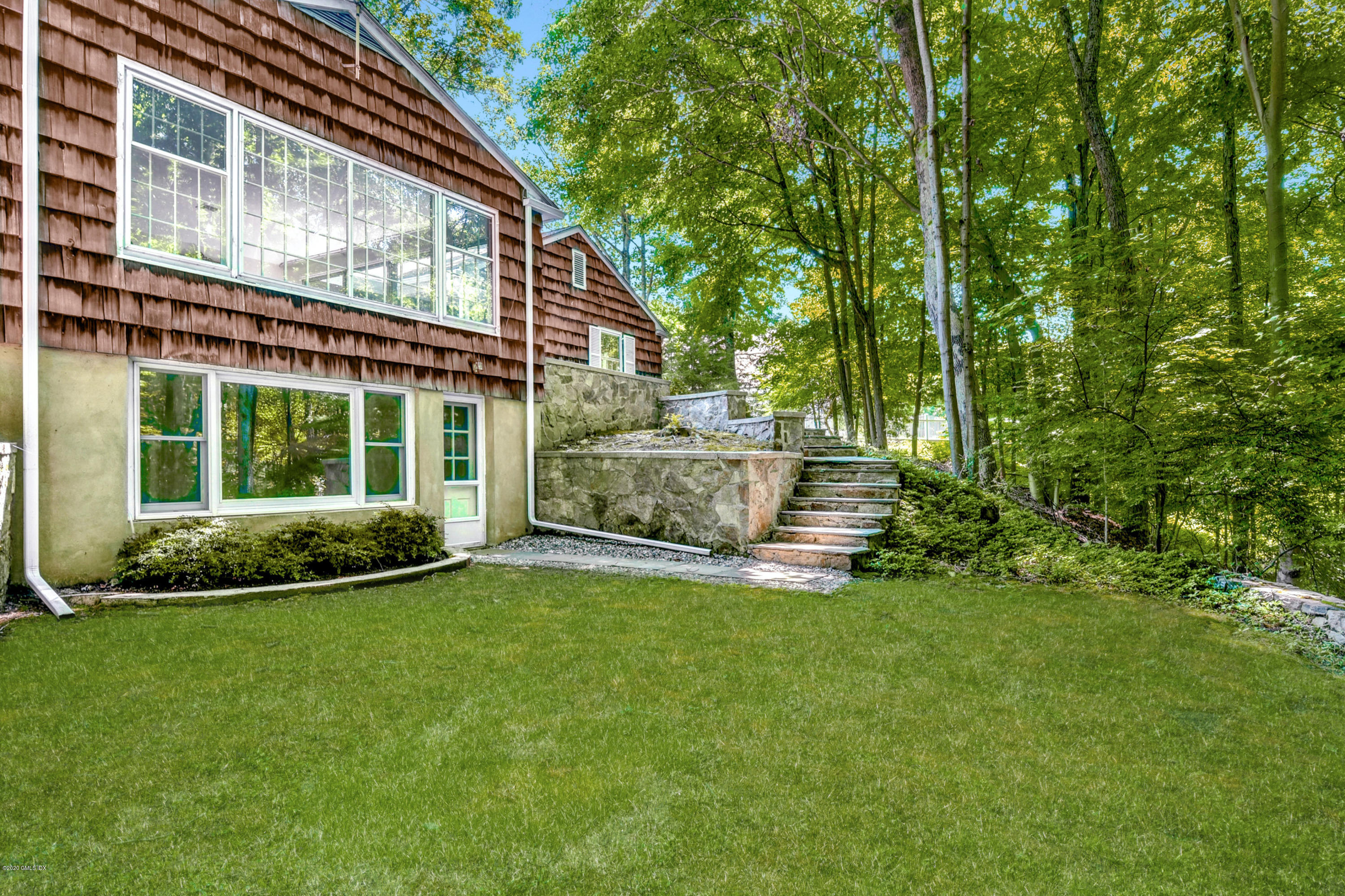 230 Stanwich Road Greenwich, CT 06830 - Photo 28 of 28 a view of a house with a backyard and porch