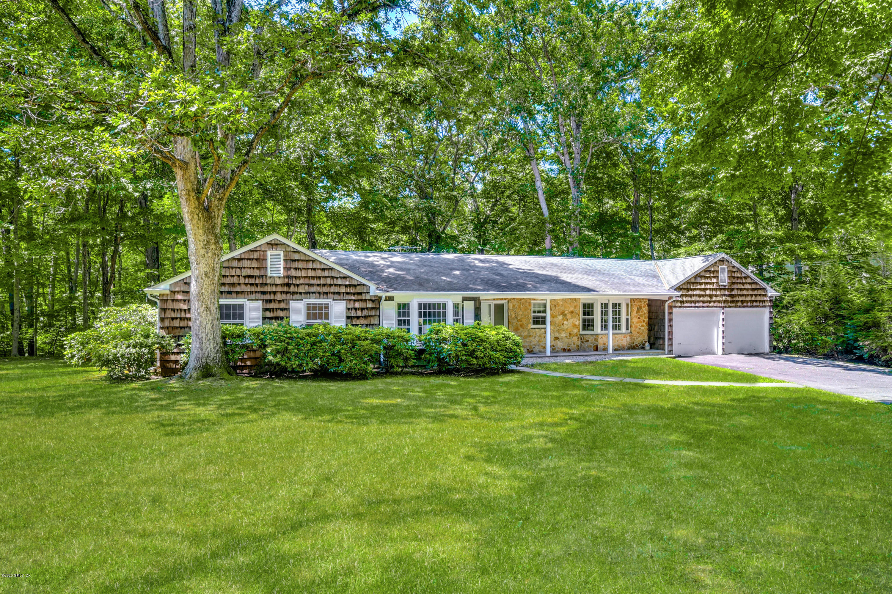 230 Stanwich Road Greenwich, CT 06830 - Photo 3 of 28 a front view of a house with a yard