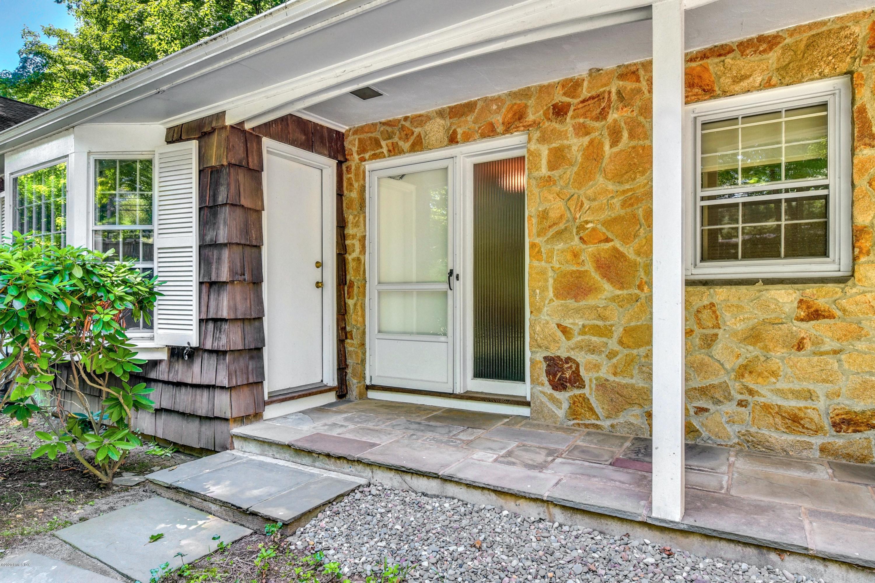 230 Stanwich Road Greenwich, CT 06830 - Photo 5 of 28 a front view of a house with a glass door