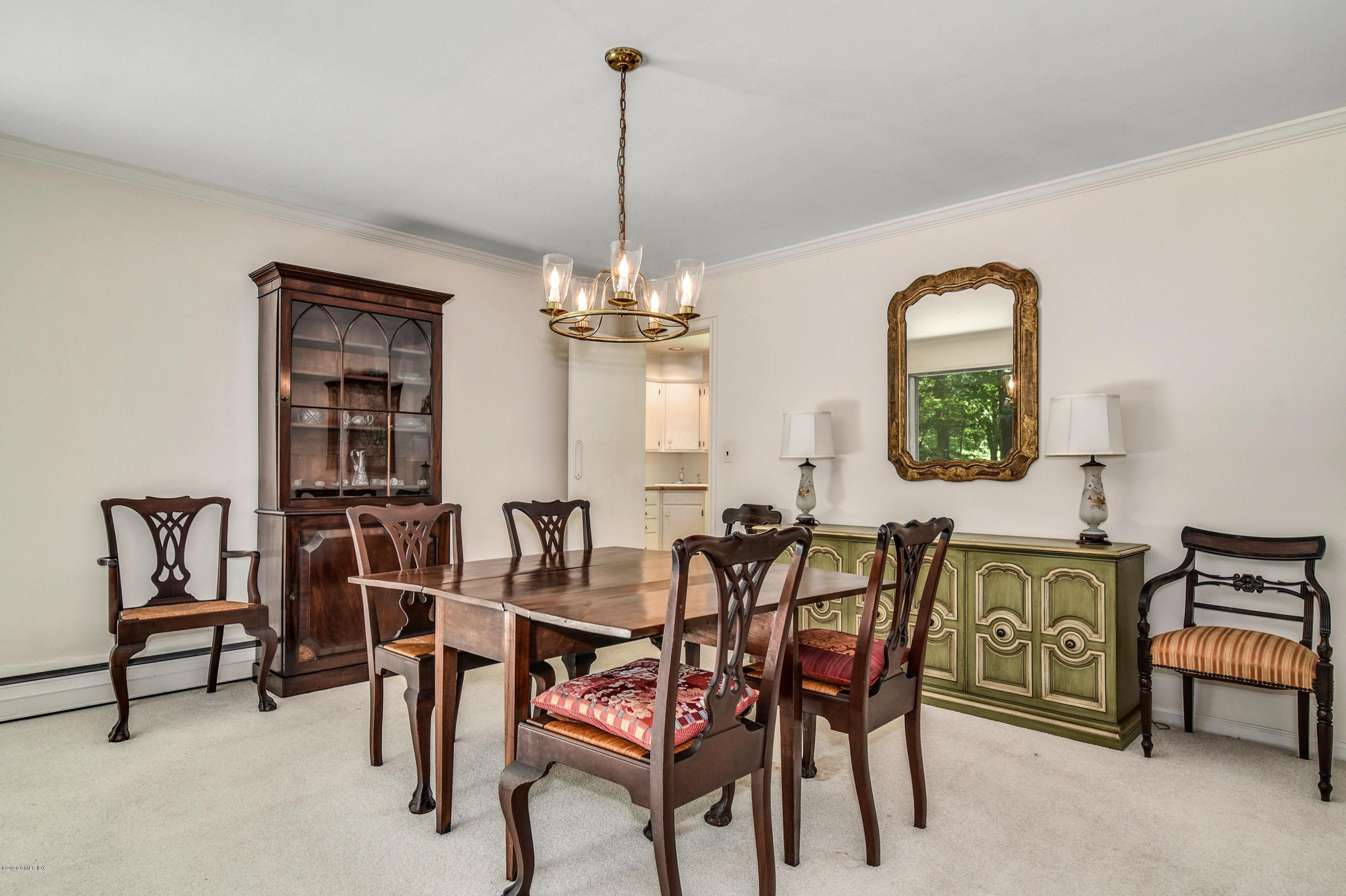 230 Stanwich Road Greenwich, CT 06830 - Photo 9 of 28 a view of a dining room with furniture and a chandelier