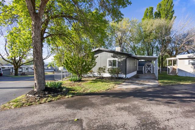 96 Barrington Way Layton, UT 84041 - Photo 24 of 28 View of front of home with an attached carport, asphalt driveway, and a front lawn