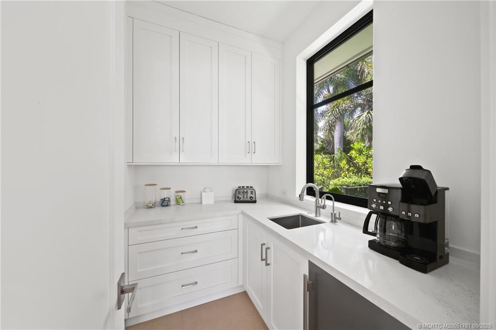 2834 Southwest Rivers End Way Palm City, FL 34990 - Photo 20 of 62 a kitchen with a sink cabinets and a window