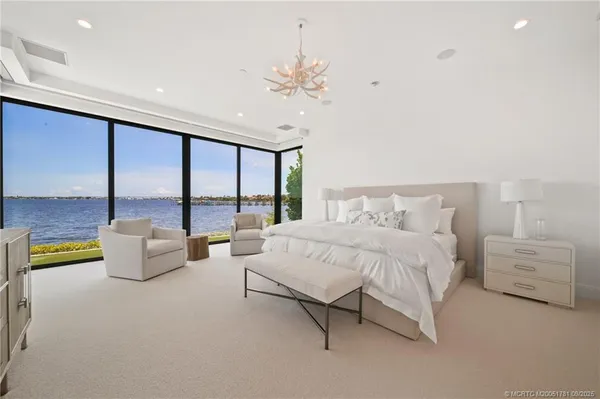 a spacious bedroom with a bed and a couch