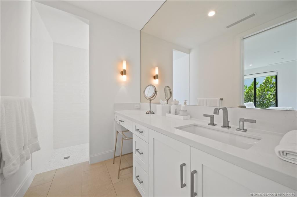 2834 Southwest Rivers End Way Palm City, FL 34990 - Photo 39 of 62 a bathroom with a sink and a mirror