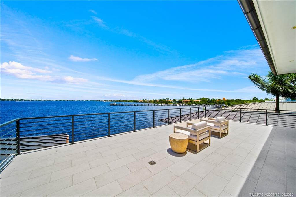2834 Southwest Rivers End Way Palm City, FL 34990 - Photo 54 of 62 a view of a roof deck with couches and city view