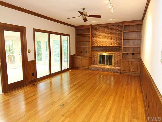 705 Sandown Place Raleigh, NC 27615 - Photo 6 of 12 Family Room also features hardwood floors, masonry fireplace, built-ins, wainscotting and chairrail. Den/Family/Great Room